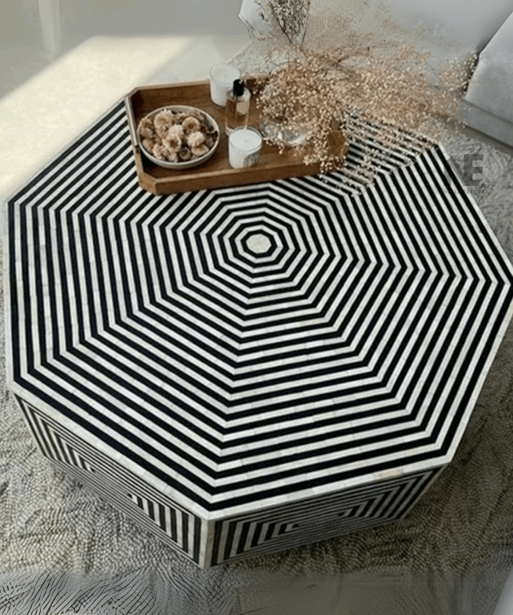 Artisan hands working on bone inlay detail on the coffee table