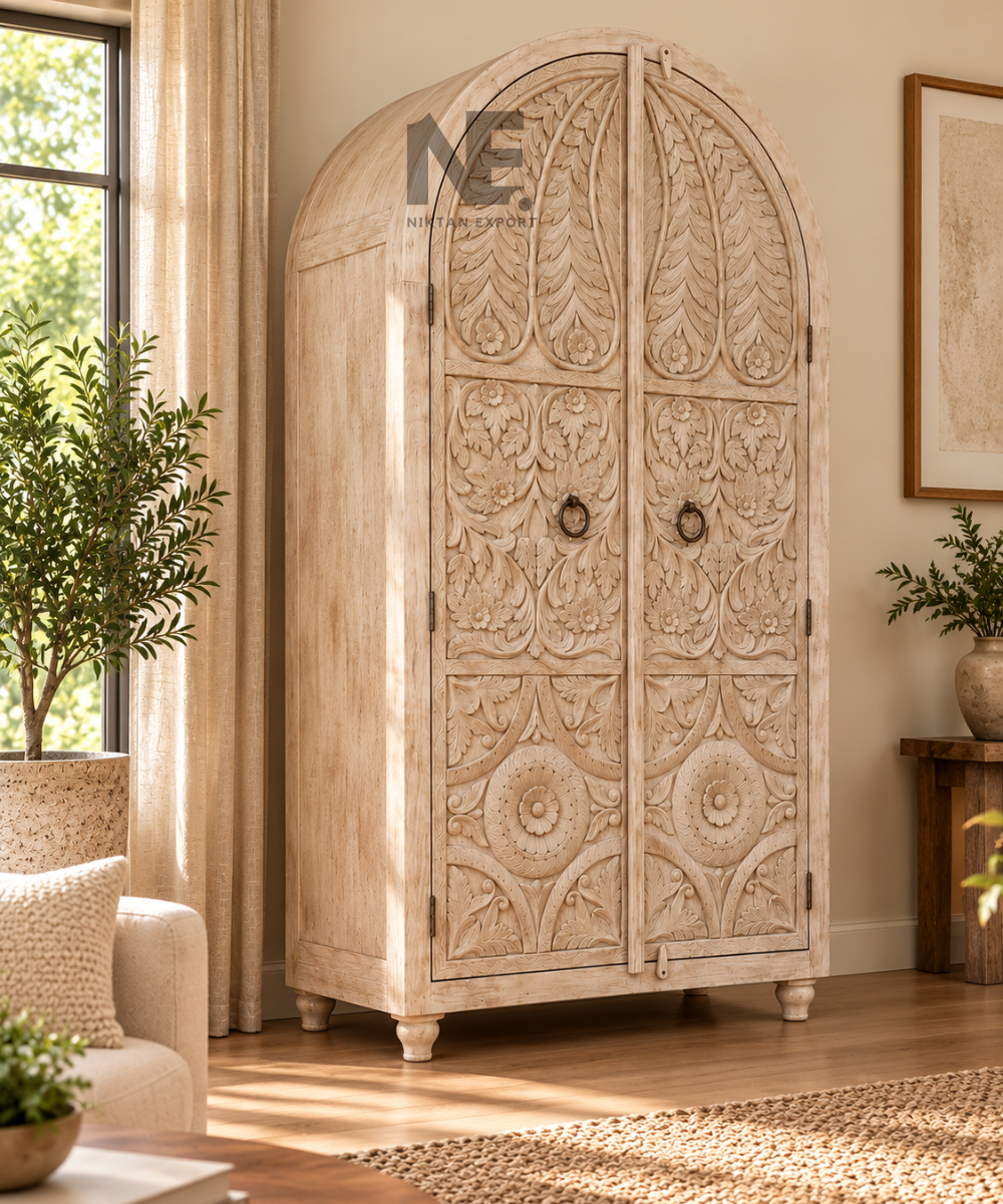 Front view of whitewashed wooden armoire with floral carvings