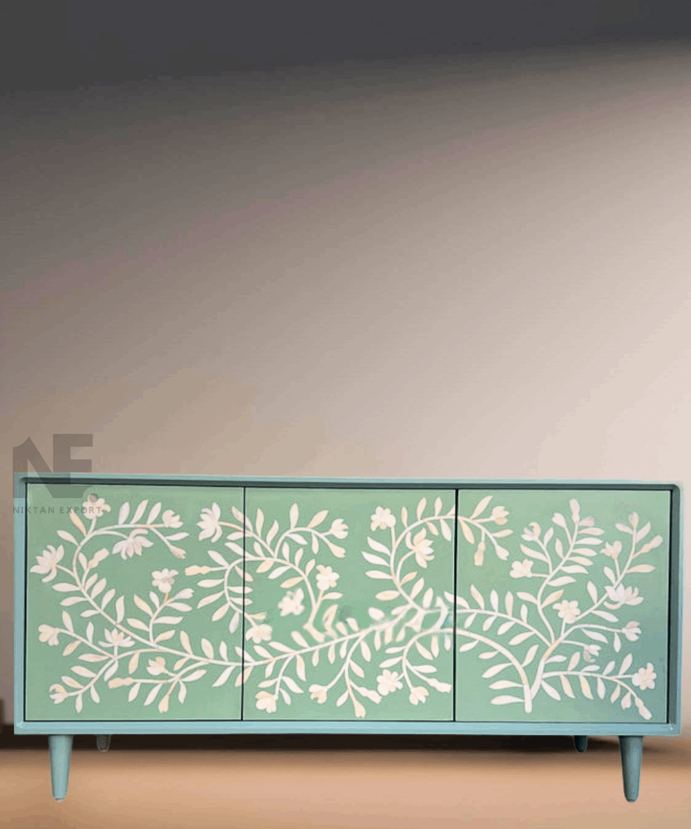 Close-up of white floral bone inlay against sage green base