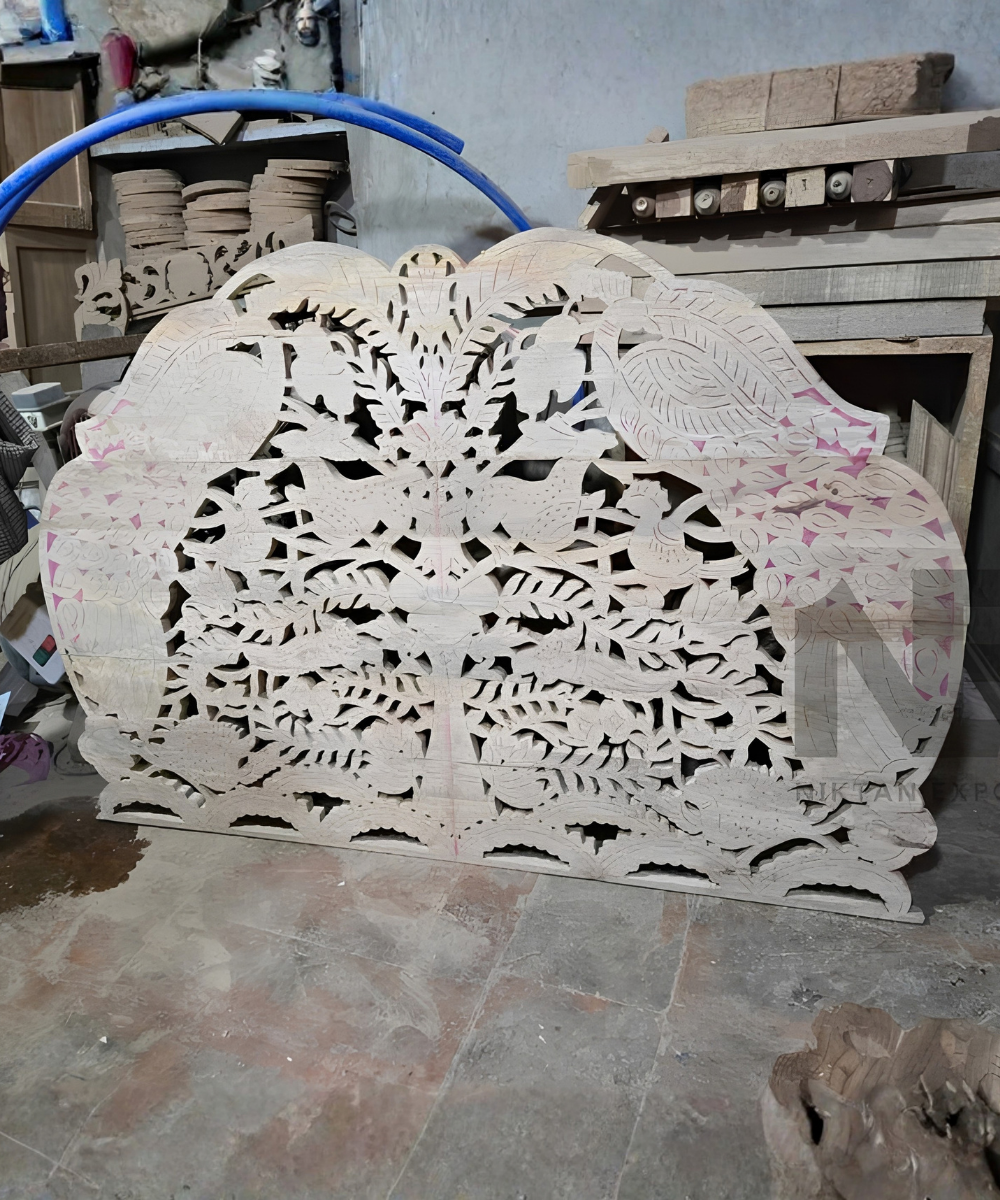 Detailed peacock carving on mango wood headboard