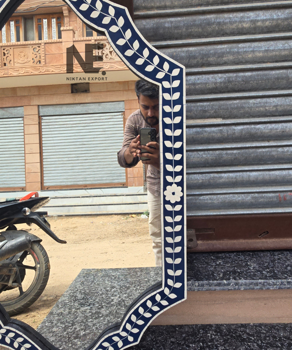 Decorative navy blue mirror with scalloped outline