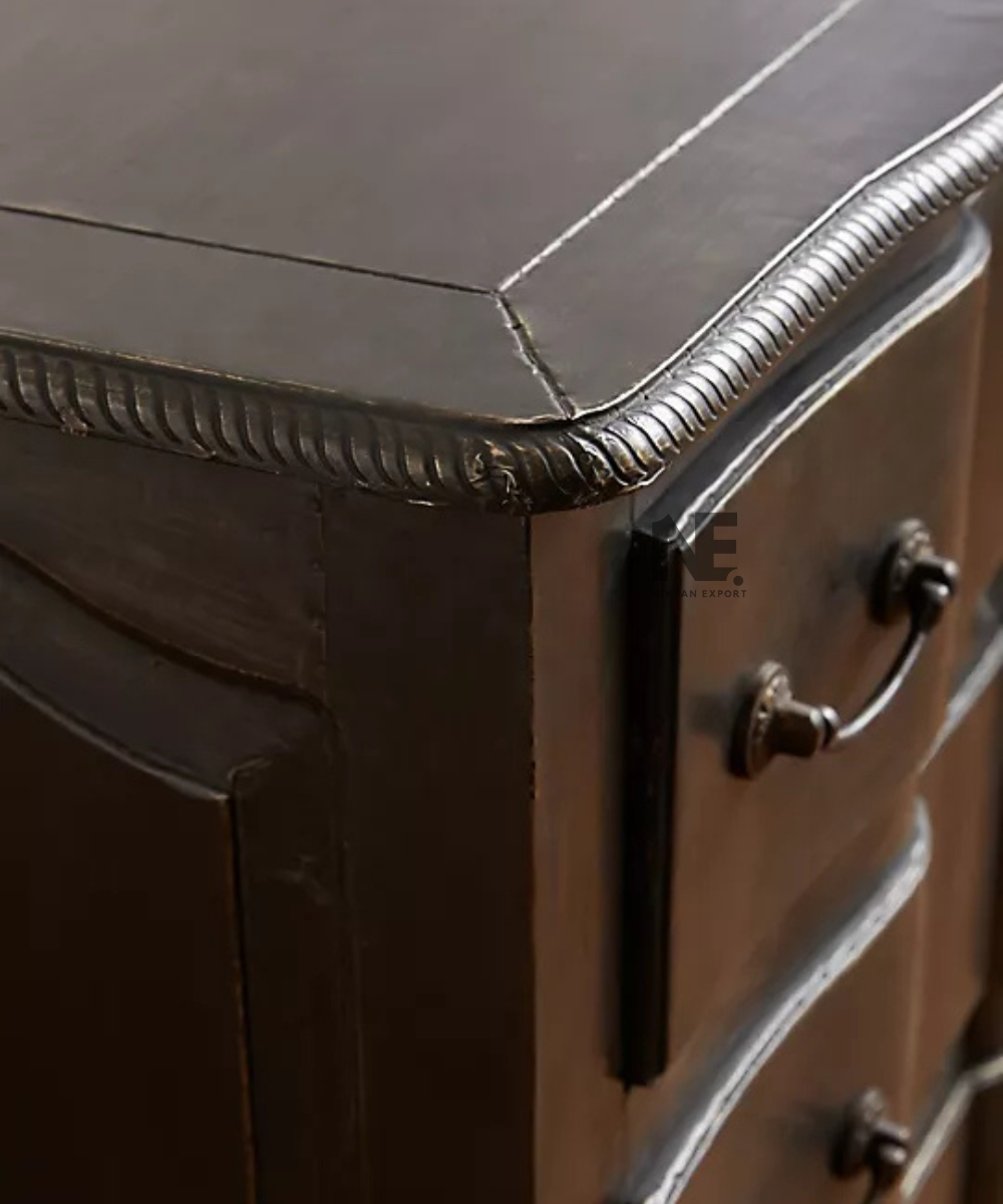 Close-up of antique-style handles on black dresser