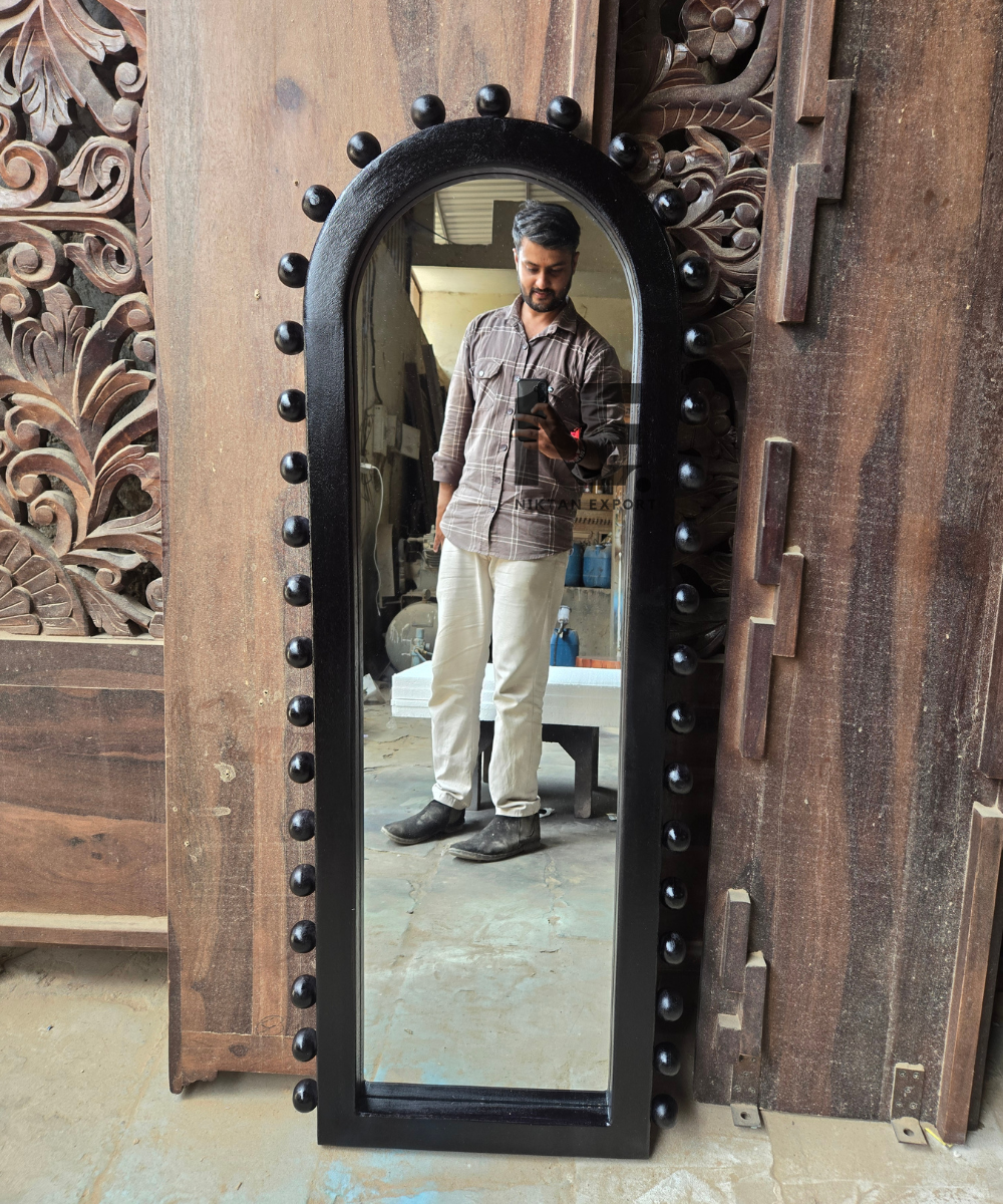 Full-length style mirror with a black arched frame