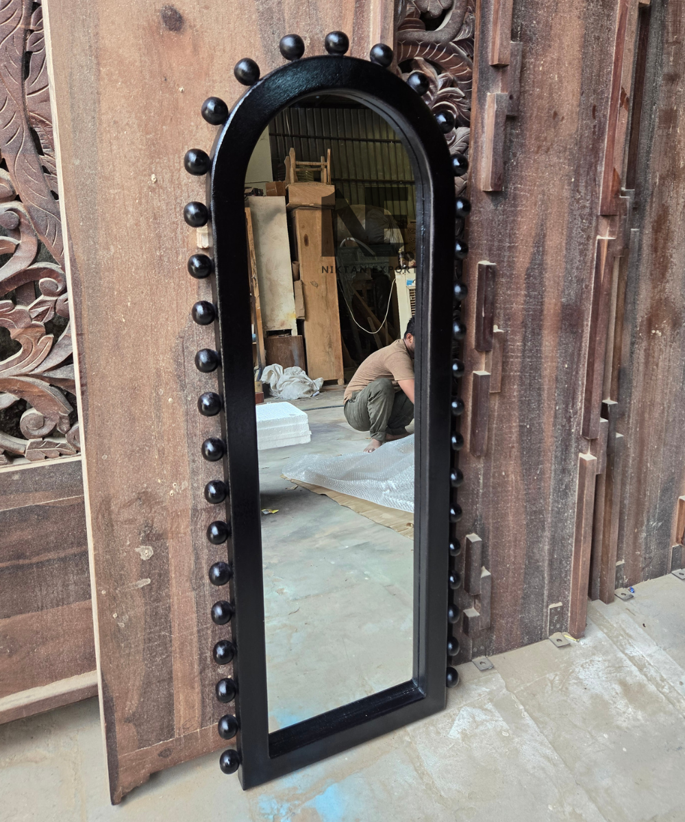 Tall arched mirror with a bold black frame