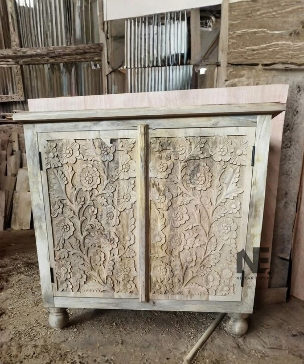 Detailed floral carving on solid wood cabinet
