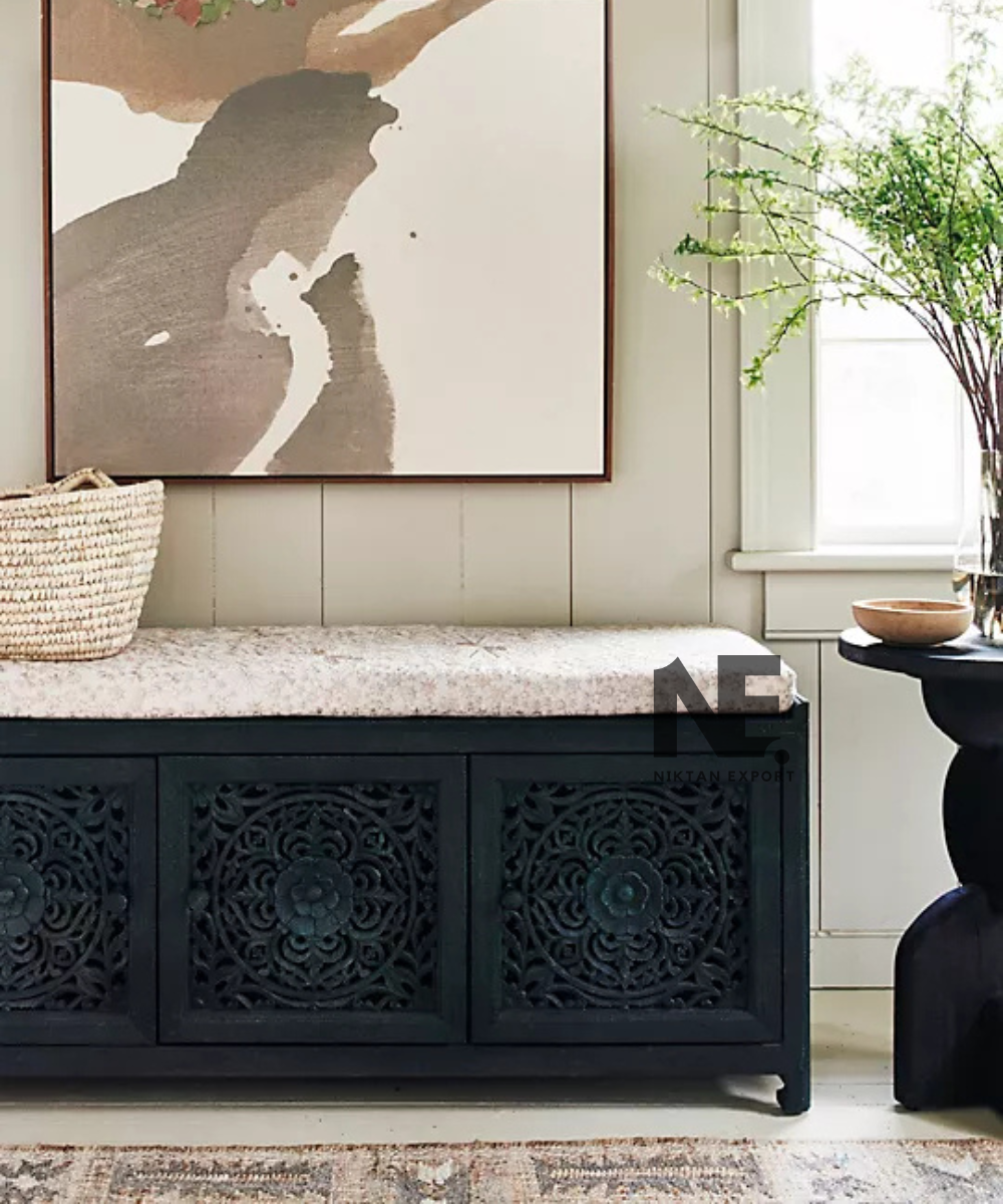 Decorative floral carving on dark teal wooden bench