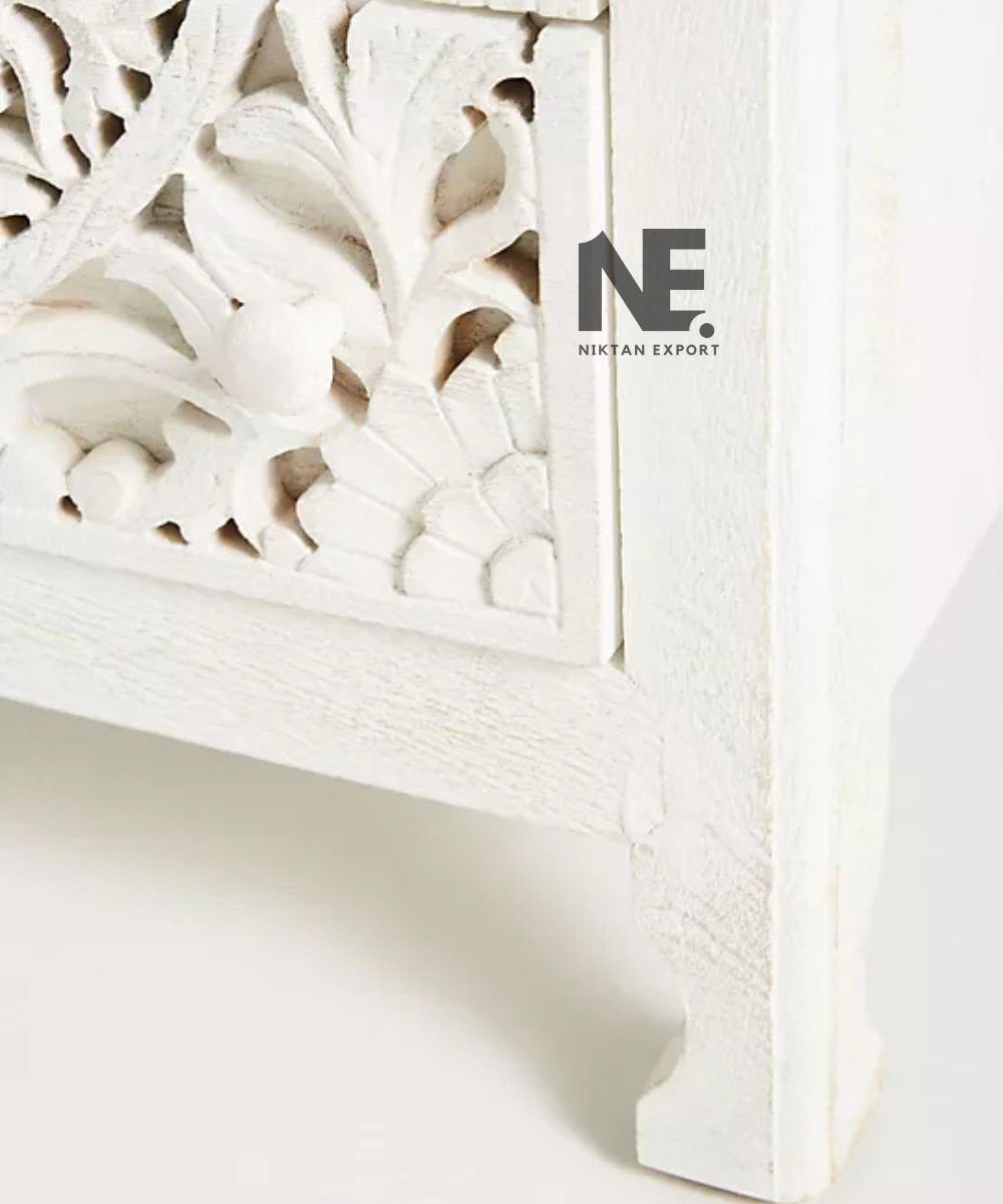 Decorative white nightstand with intricate floral detailing