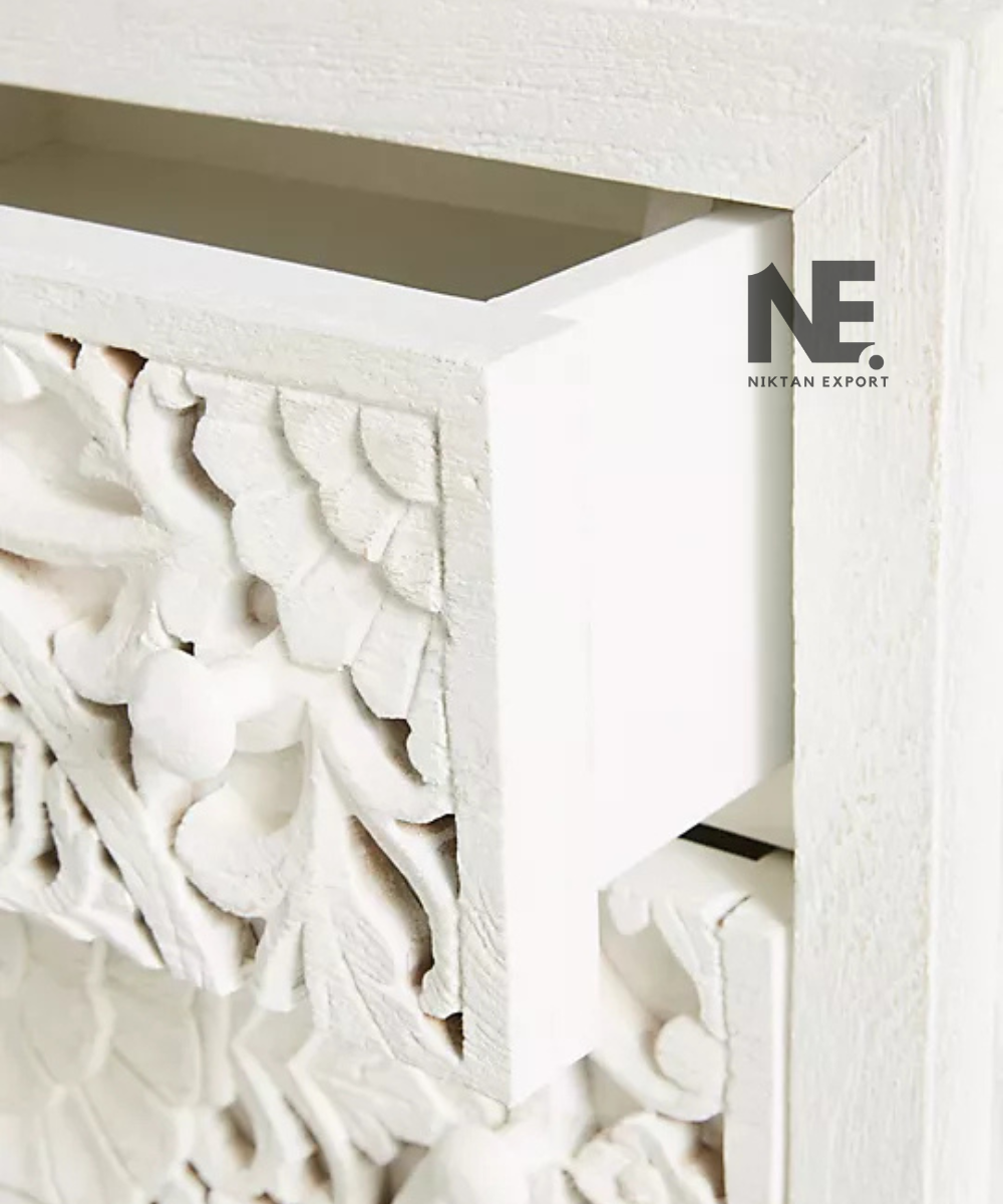 Close-up of floral carving on white wooden drawer fronts