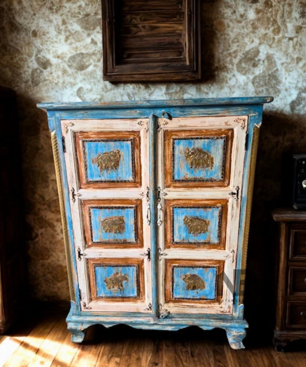 Blue distressed wooden cabinet with elephant panels