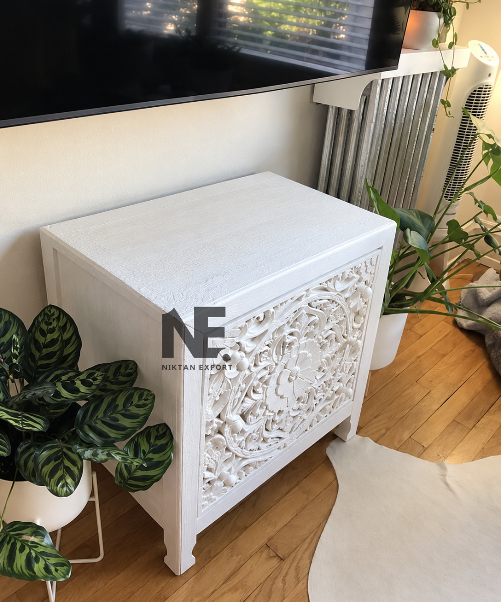 Front view of white bedside table with floral carved drawers