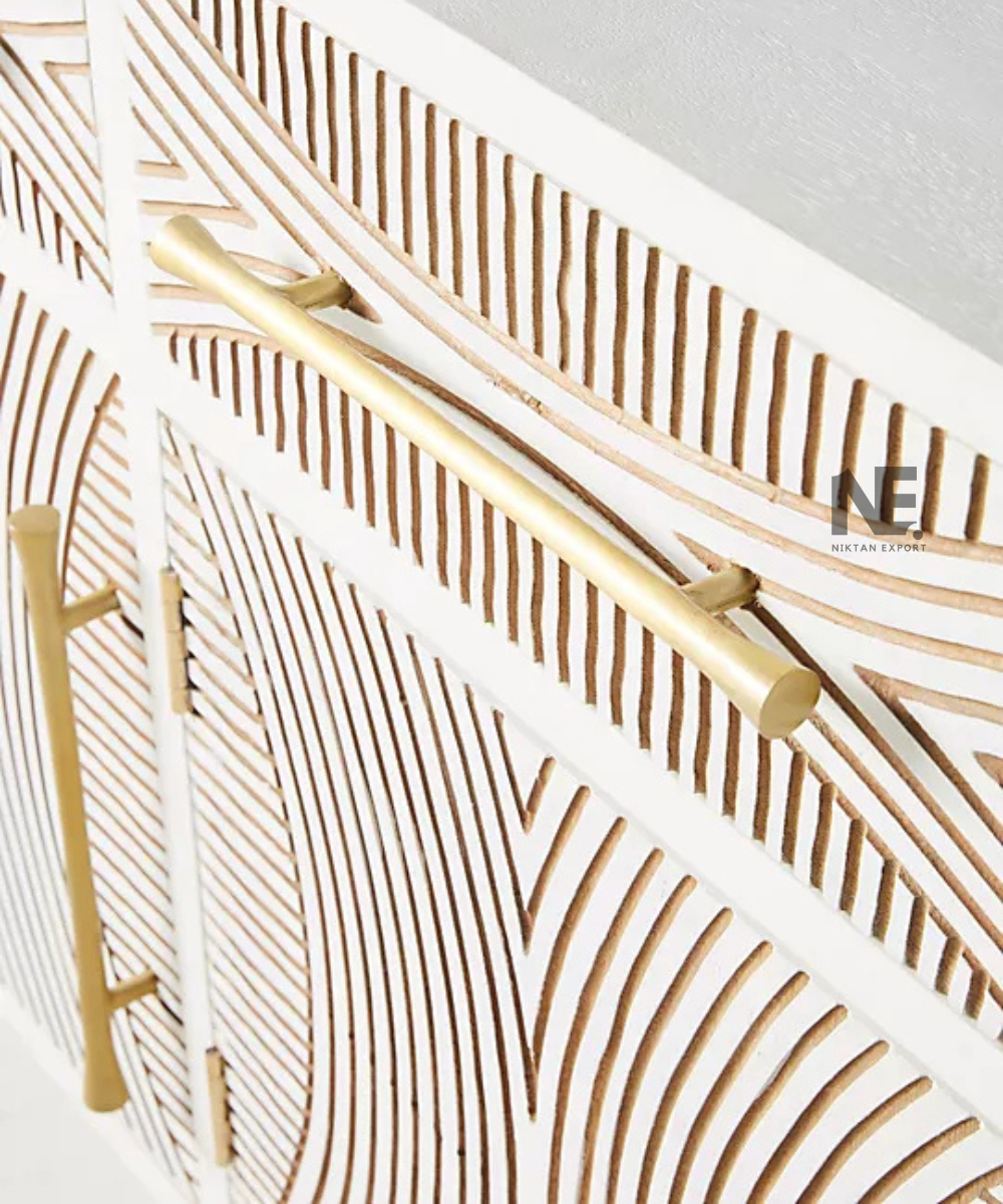 Close-up of gold-tone geometric detailing on white sideboard