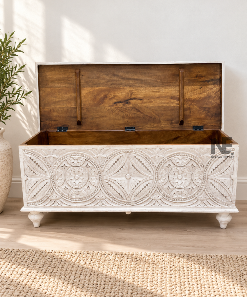 Detailed floral mandala carving on whitewashed storage chest