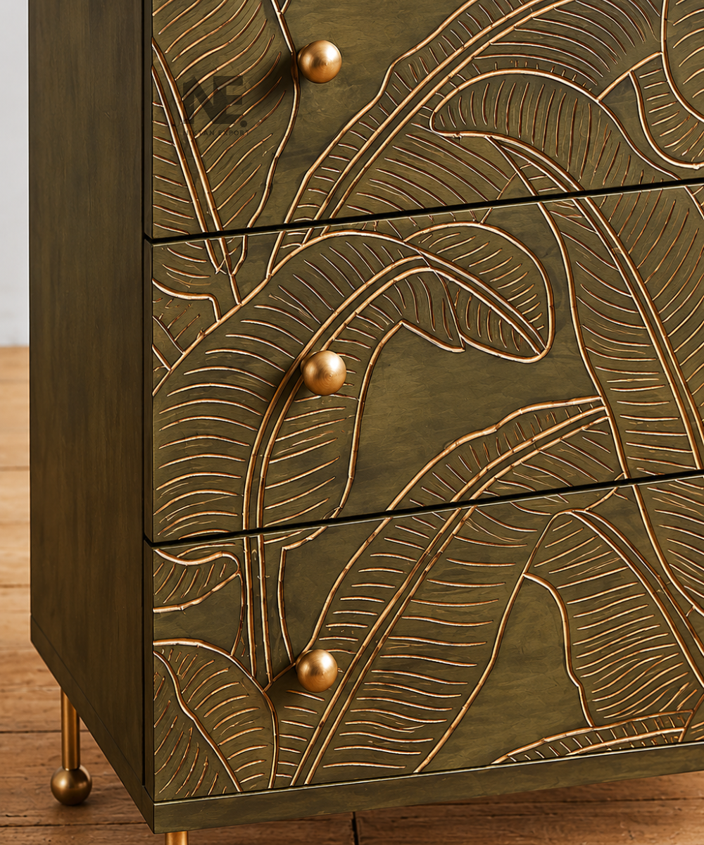 Decorative tropical leaf carving on wooden chest of drawers