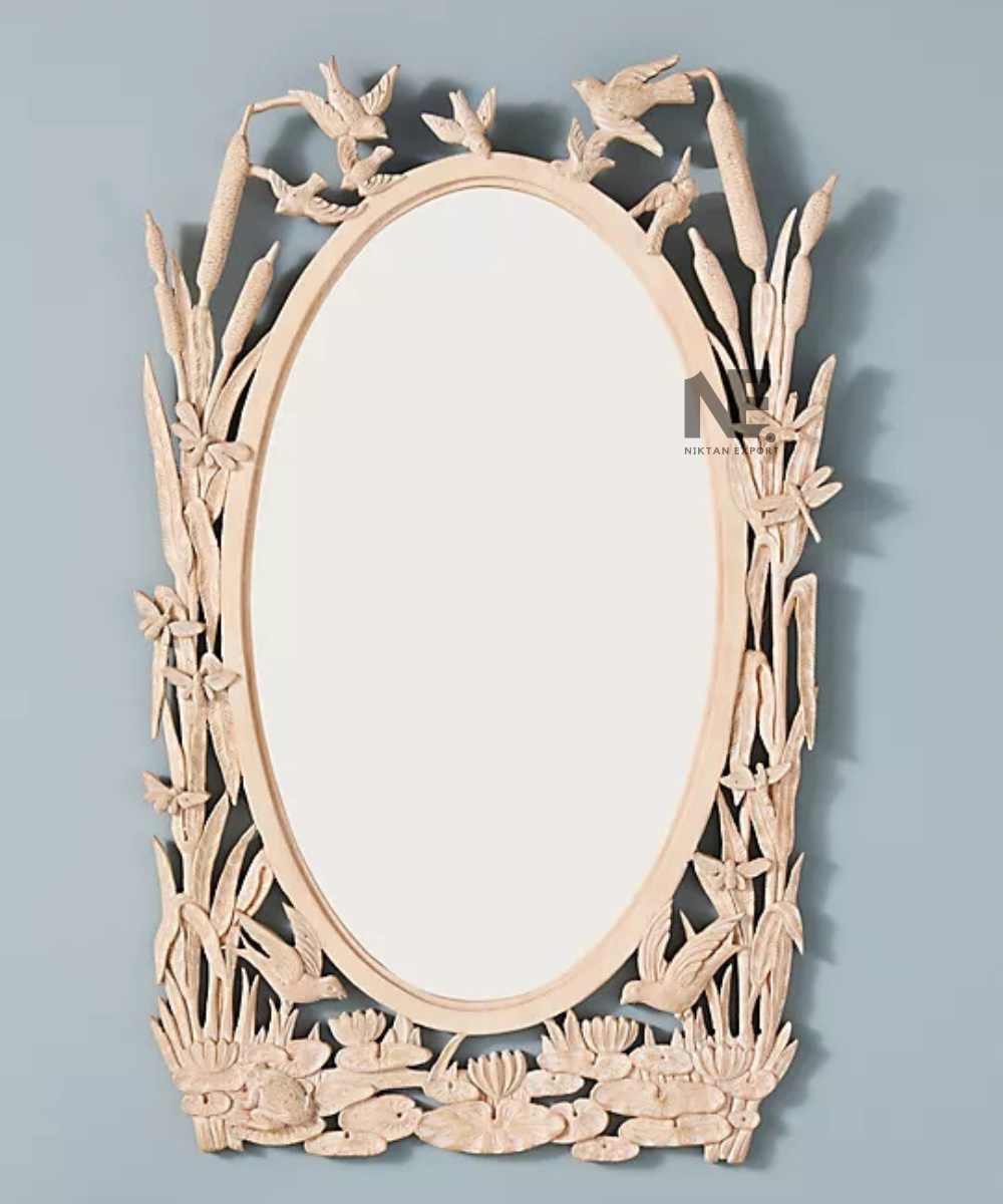 Floral details on a hand-carved oval mirror frame