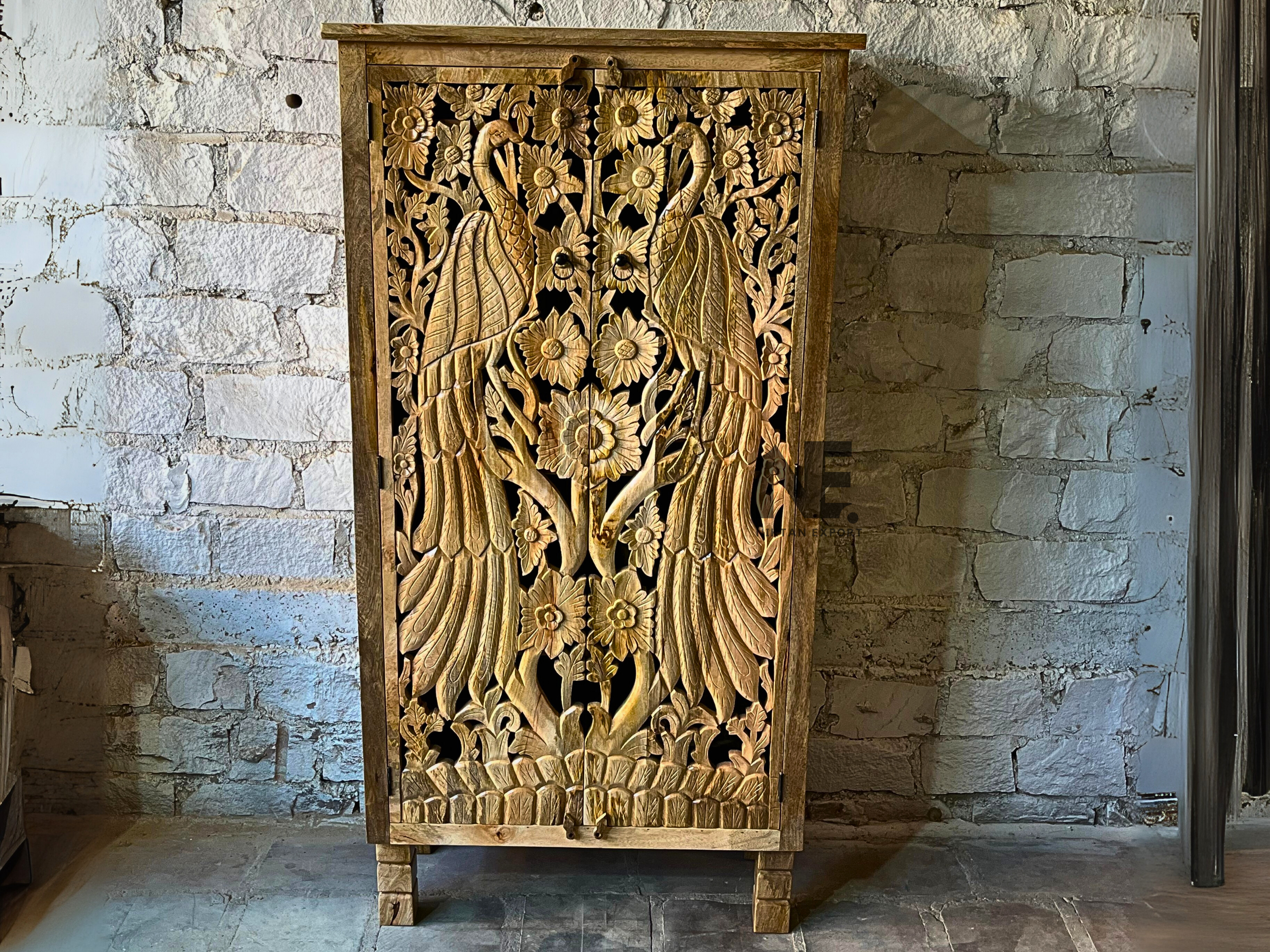 Hand-carved peacock armoire made from solid mango wood for elegant home storage