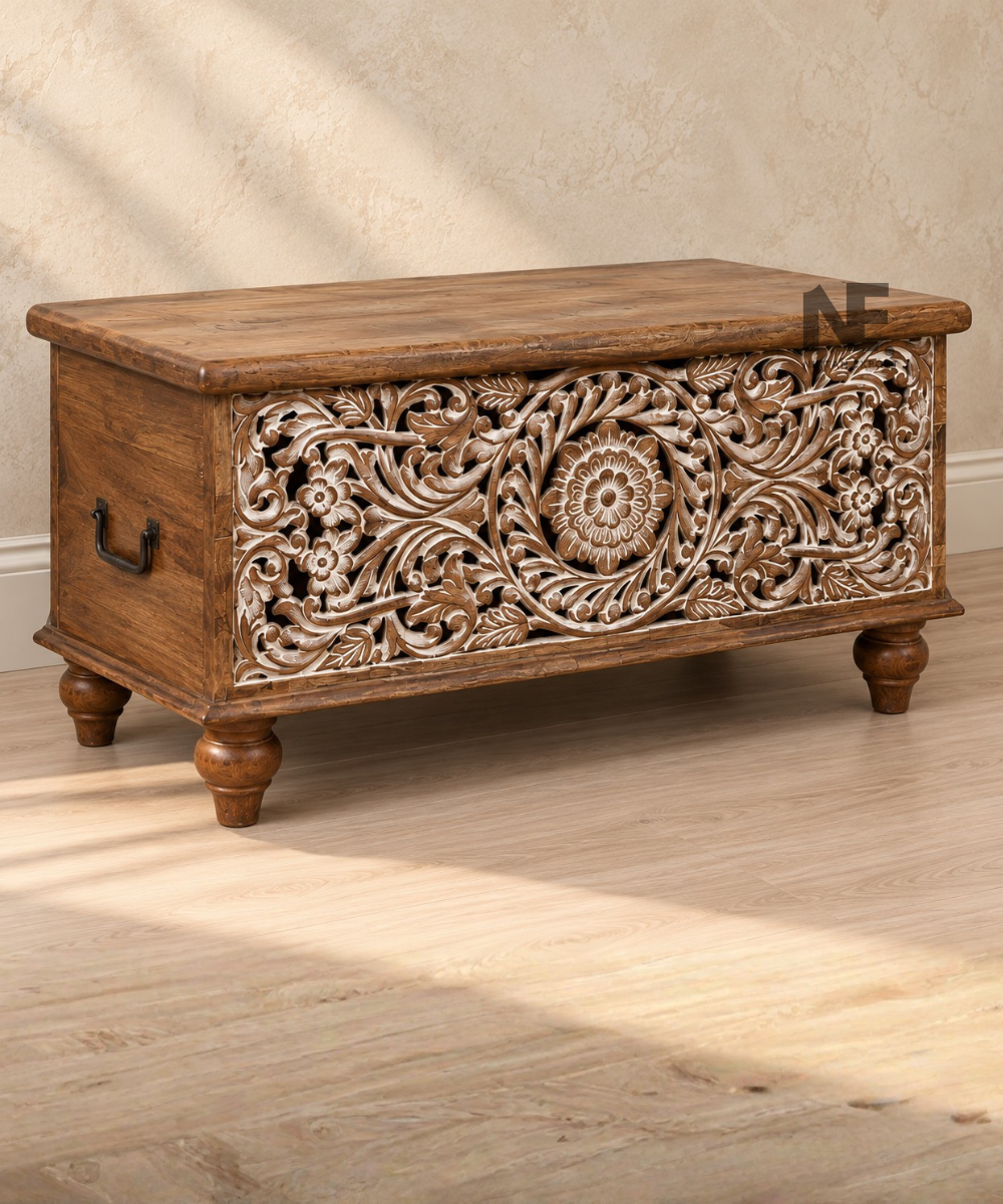 Front view of brown wooden storage trunk with whitewashed carving