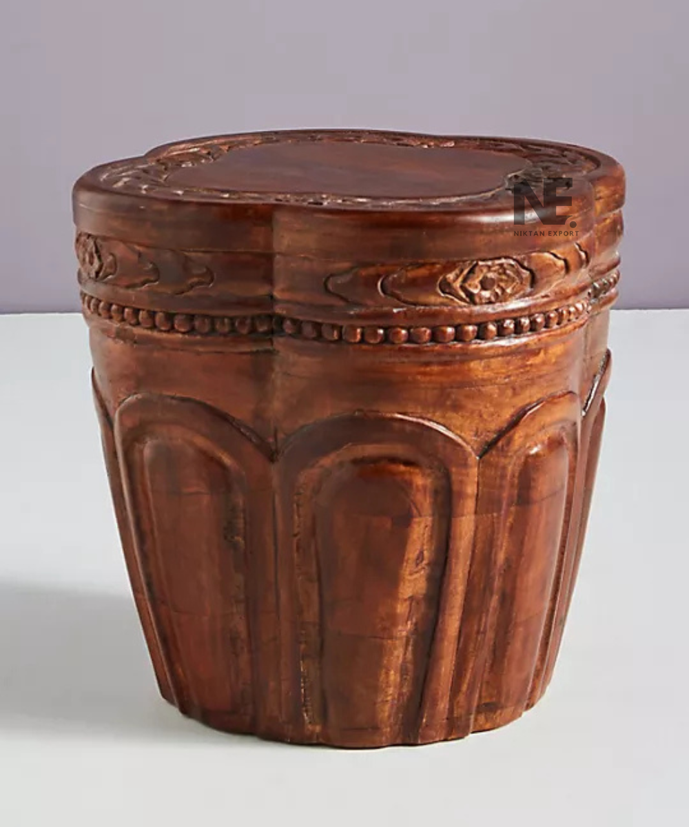 Front view of round wooden side table with carved details