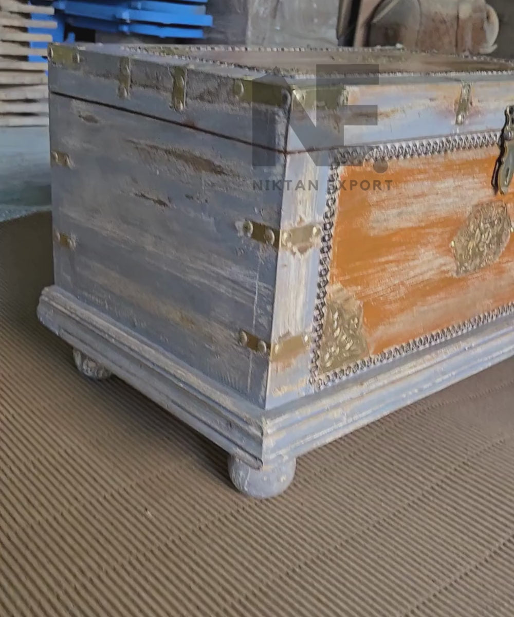 Weathered blue-grey finish on wooden storage trunk