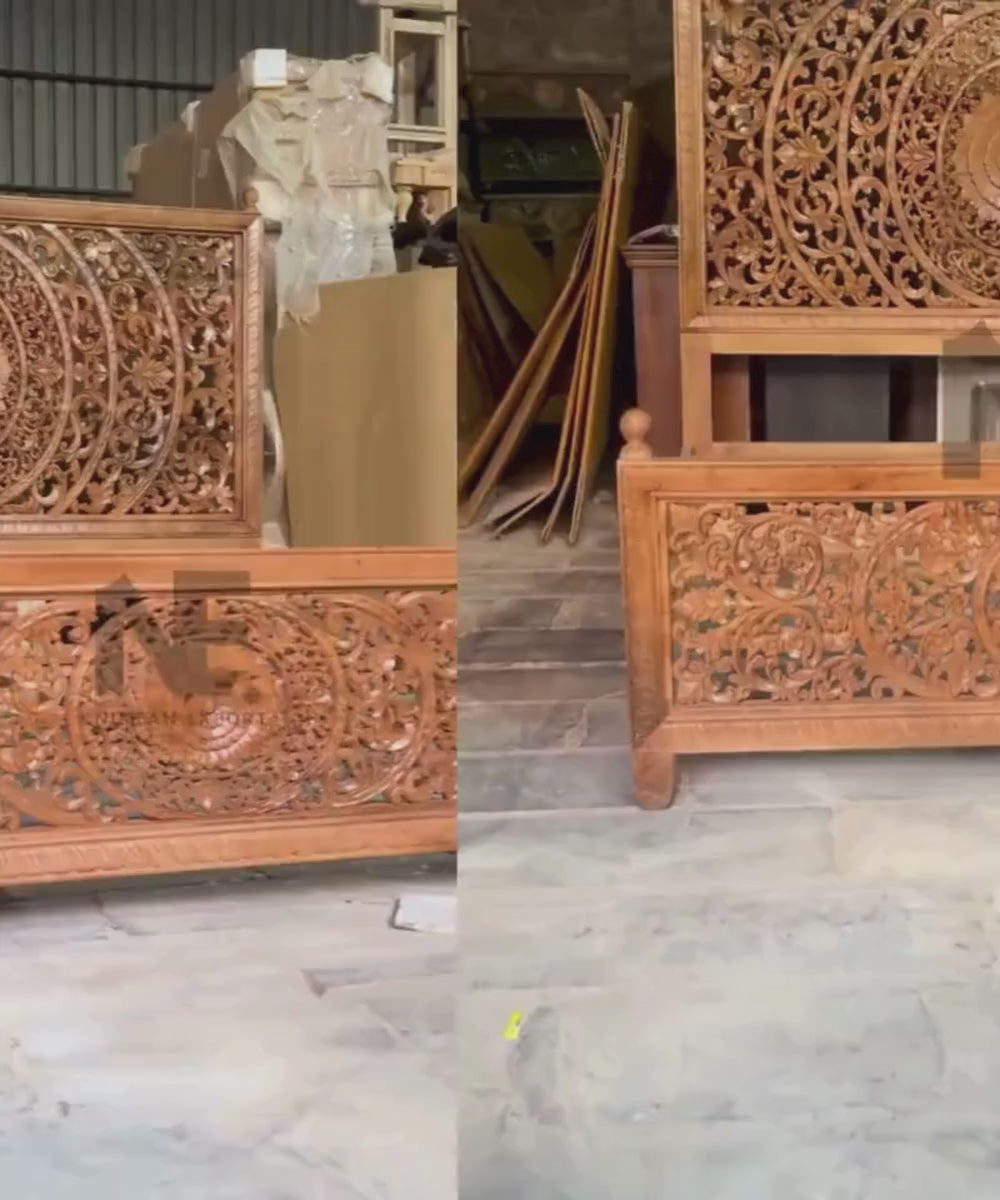 Detailed floral scrollwork on carved king bed