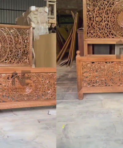 Detailed floral scrollwork on carved king bed
