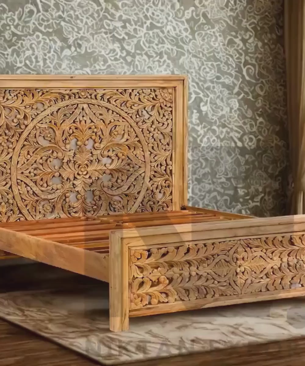 Ornate carved wooden headboard on mango wood bed