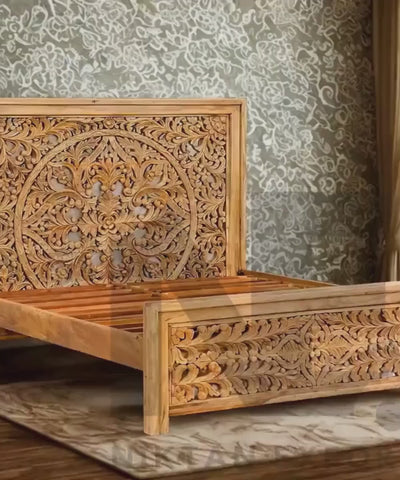 Ornate carved wooden headboard on mango wood bed